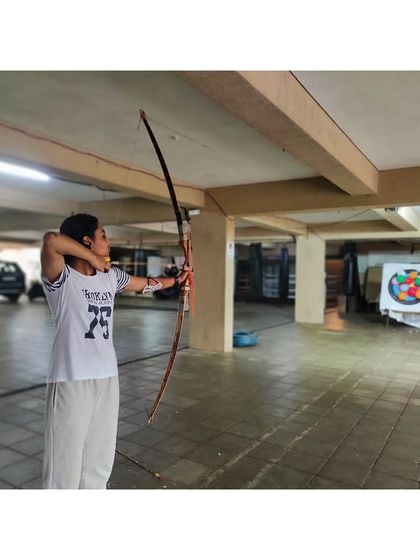 A student at full draw, demonstrating the strength and control developed during our training drills.