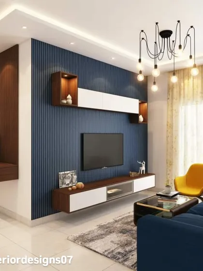 A bold living room design featuring a blue fluted accent wall for the TV unit. The floating shelves and console in white and wood provide a sharp, modern contrast.
