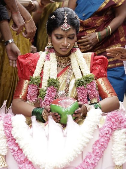 A beautiful, traditional moment from the wedding ceremony. Our bride Naveena looks serene and elegant in a classic temple choker and maang tikka set.