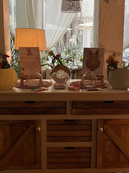 An activity station for the baby shower, where guests could write messages for the baby. We decorated the station with small floral arrangements and themed cards to keep it cohesive with the overall decor.