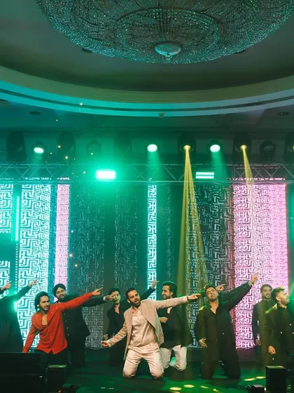 The men of the family striking a powerful pose during their group performance.