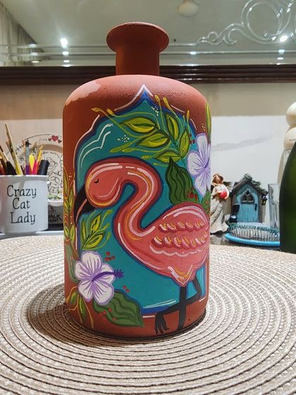 This terracotta bottle was beautifully painted during our online workshop. The artist's bold lines and vibrant colors really make the flamingo design pop.