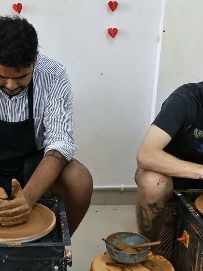 Friends concentrating side-by-side on the pottery wheel. A great way to spend an afternoon.