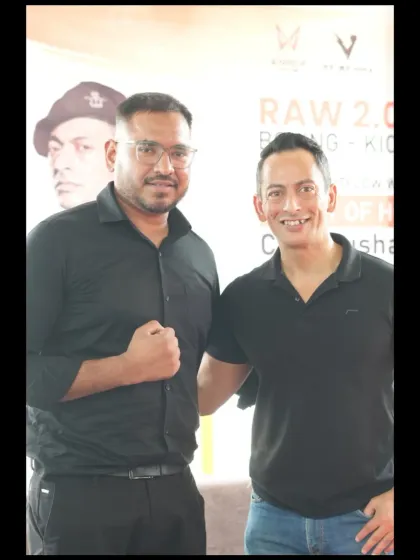 Our head coach with an official at the RAW 2.0 Championship, highlighting our respected presence in the Indian MMA community.