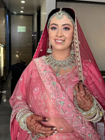 A beautiful moment with my niece on her wedding day. Her phera look in pink is complemented by soft, defined makeup and a traditional nath, creating a perfect blend of modern and classic.