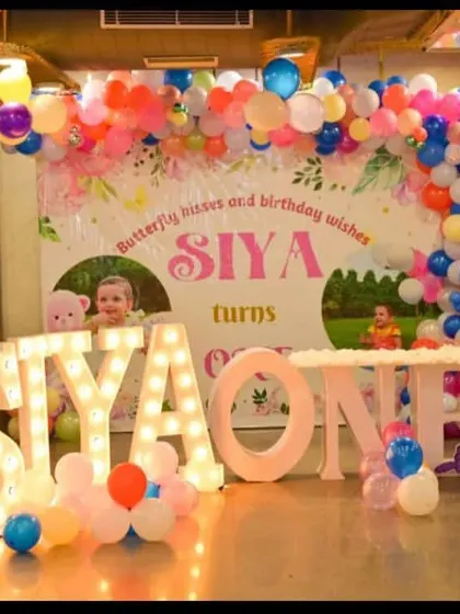 This butterfly-themed first birthday for Siya was so much fun to create. The stage features a colorful balloon arch, a personalized backdrop, and light-up letters spelling her name.