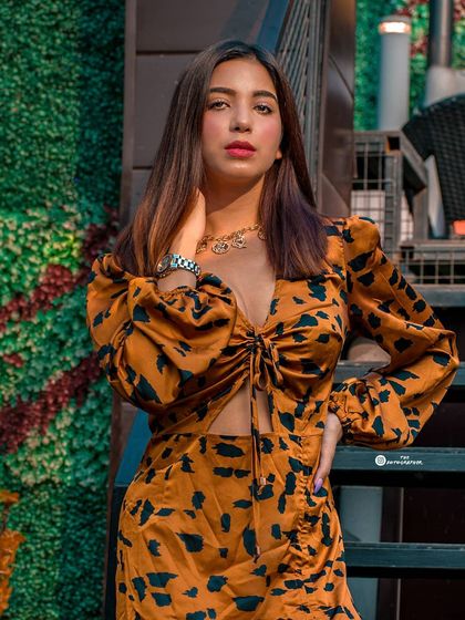 A stylish shot from an outdoor cafe, perfect for an influencer's lookbook. The composition uses the stairs to create a dynamic angle.