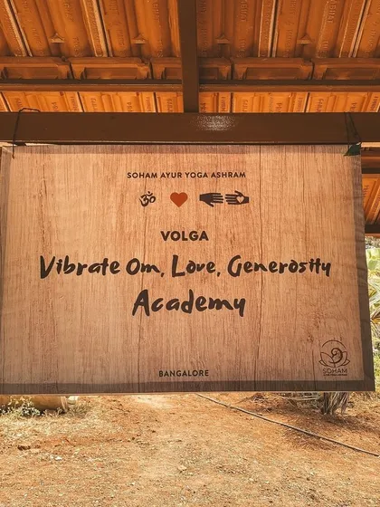 Our academy sign: Vibrate Om, Love, Generosity. This is our mission and the energy that defines our community and everything we do.