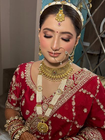 My stunner bride, ready for her big day. We created a classic bridal look with a focus on defined eyes and a flawless base, complemented by her beautiful red saree.