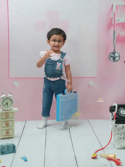 Is there a doctor in the house? This little one looks ready for her rounds in our adorable doctor-themed setup, complete with a mini briefcase and a pink clinic backdrop.