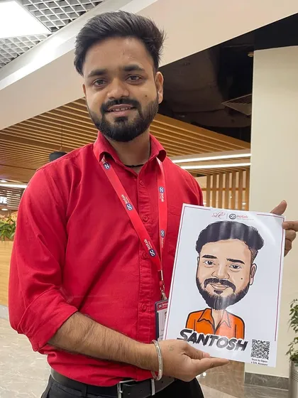 A client proudly holding his finished digital caricature at a corporate event. These portraits are printed instantly, making them a great interactive giveaway.