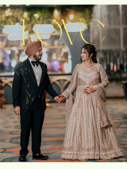 A classic couple portrait of Sahib and Ravleen holding hands. The grand, well-lit venue in the background adds to the elegance of their engagement look.
