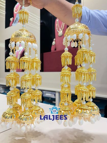 A classic golden kaleera with white shell-like drops, perfect for a traditional Punjabi wedding.