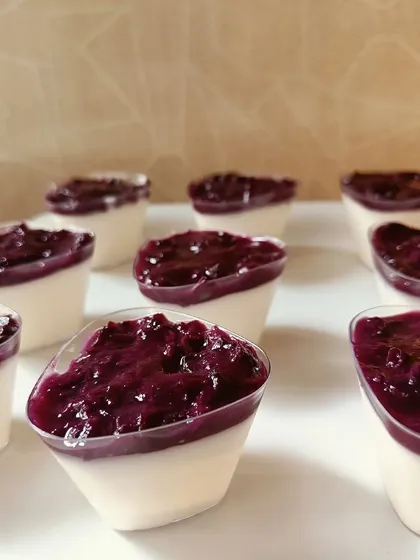 When jamuns are in season, I make these beautiful panna cottas. The creamy, wobbly pudding is topped with a vibrant, tangy compote made from fresh jamuns. It's a simple, elegant, and fully vegetarian dessert.