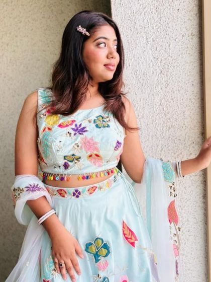 A lovely shot of a client wearing my hand-painted pastel blue lehenga. The colorful floral motifs on the blouse and skirt are perfect for a spring or summer event.