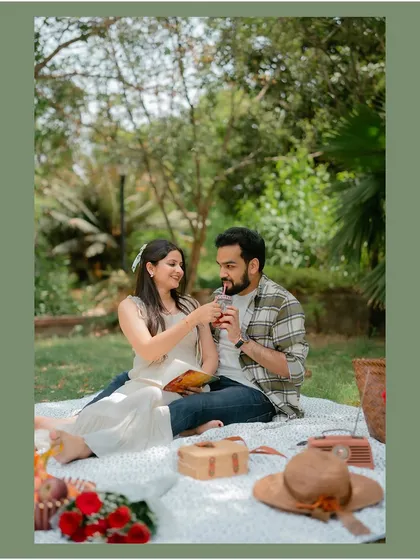 A sweet moment of the couple sharing a drink during their romantic picnic, highlighting the small, intimate gestures.