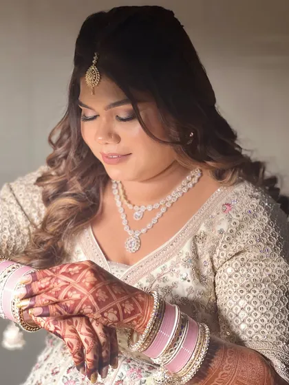 A close-up of the bride's engagement look. The makeup is soft and romantic, with a beautiful glow that enhances her features.