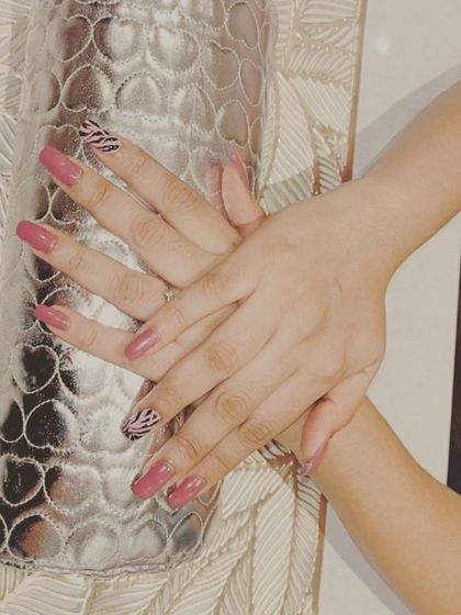 A touch of the wild side. This design features a chic mauve polish paired with a striking zebra print accent nail, creating a look that is both trendy and sophisticated.