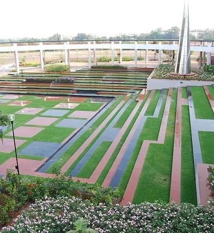 Another perspective of the modern podium garden, highlighting the long, linear elements and a central sculpture.