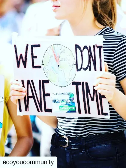 "We Don't Have Time." This simple, direct message on a protestor's sign, with a clock ticking over the planet, perfectly encapsulates the urgency of the climate emergency.