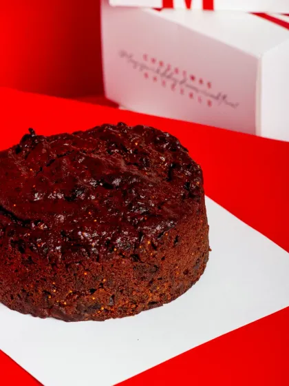 A close-up of the glossy, fruit-studded top of the cake.