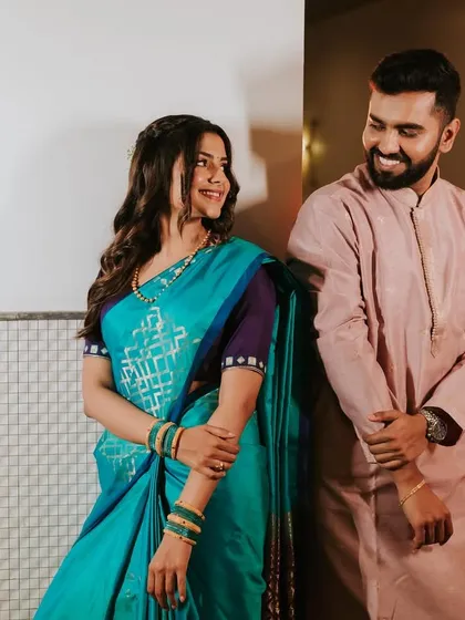 A playful and happy couple. The bride's makeup is natural and radiant, capturing their joyful interaction.