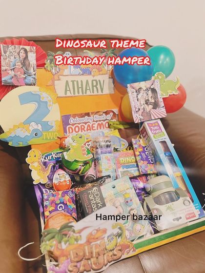 Roar! A dinosaur-themed birthday hamper for Atharv's second birthday, packed with toys, snacks, and coloring books.