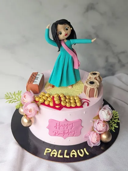 A cake designed for a Kathak dancer. I handcrafted the figurine to capture the graceful pose of the dancer, complete with ghungroos, a harmonium, and tablas.