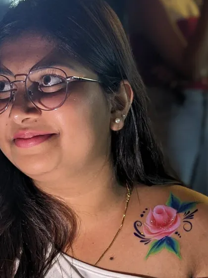 Elegant body art is a beautiful addition to weddings and corporate events. This single pink rose painted on the shoulder is a classic, timeless design that adds a touch of grace.