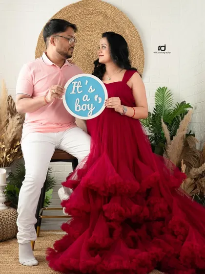 "It's a boy!" Using props to announce your baby's gender is a fun part of any maternity shoot. This couple's joy is captured perfectly in our boho studio setup.