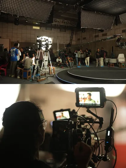 A wide shot of the studio during the CRED shoot, showing the large overhead softboxes and lighting grid used to control the environment.