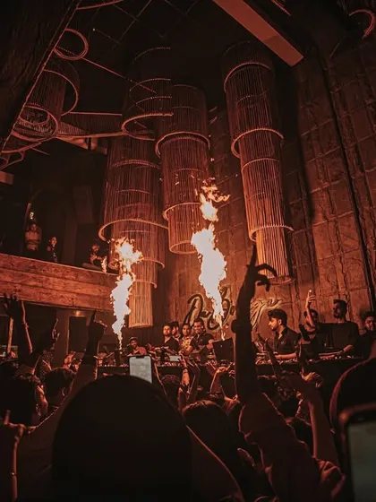The crowd's hands are up as the fire jets go off. An unforgettable night at Da Bodega.