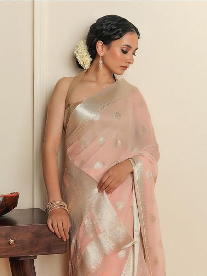 An elegant shot of the "JASHN" saree by Binal Patel, styled in our room corner set for a soft, traditional feel.