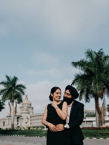 A duplicate of image 57, a classic couple portrait with the grand architecture of Vidhana Soudha providing a timeless and elegant backdrop.