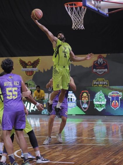 An athletic layup in traffic during a professional game. This is the result of countless hours spent on finishing drills.