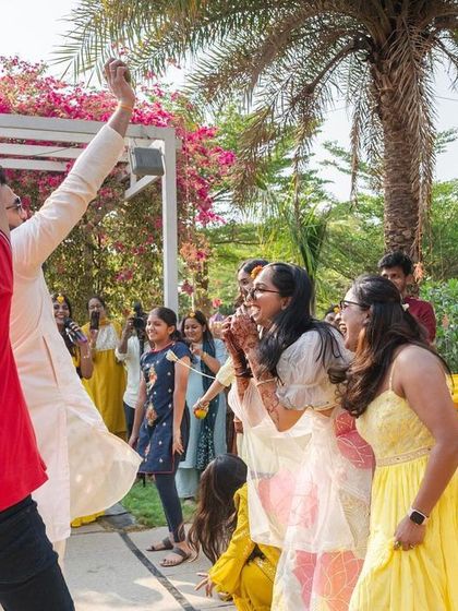 The groom makes a grand entrance at the Haldi ceremony, dancing with friends and family in a joyous celebration.