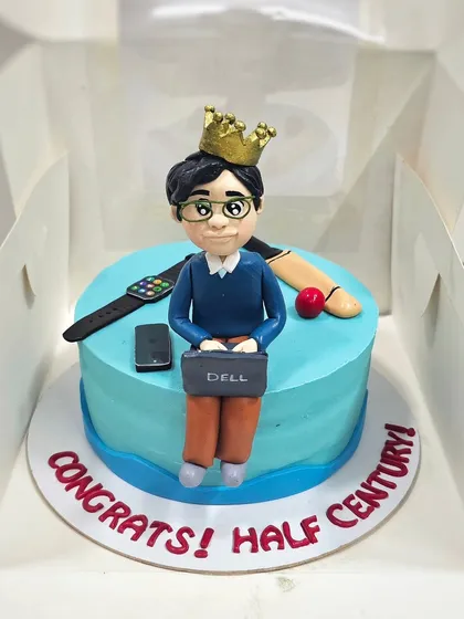 A "Congrats! Half Century!" cake for a 50th birthday, personalized with items representing the person's interests, like a laptop, watch, and cricket bat.