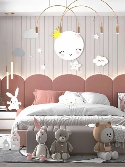 Sweet dreams are made of this. We designed this room around a celestial theme, with a smiling moon wall light, star decals, and cloud-shaped pillows for a gentle, dreamy atmosphere.