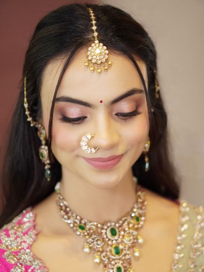 A close-up of Likitha's soft and shimmery eye makeup. The delicate pink and gold tones are perfect for enhancing her features without being overpowering.