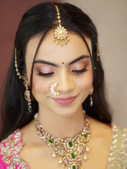 A close-up of Likitha's soft and shimmery eye makeup. The delicate pink and gold tones are perfect for enhancing her features without being overpowering.