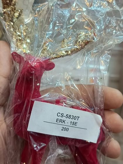 A beautiful red reindeer ornament with glittery gold antlers. This is just one example of the many unique and high-quality Christmas decorations I stock for the holiday season.