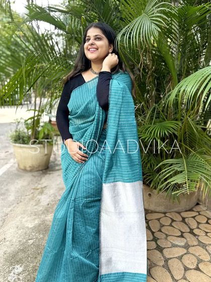 The teal blue version of our striped handloom cotton saree. This color is so refreshing and perfect for warm weather, offering a cool and comfortable drape.