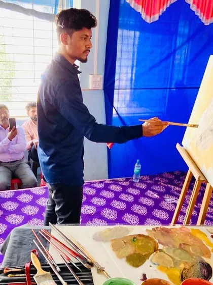 Here I am applying the initial layers of color for a portrait at the Nav Krishna Valley College demonstration. The process begins with broad strokes to establish the composition and color harmony.