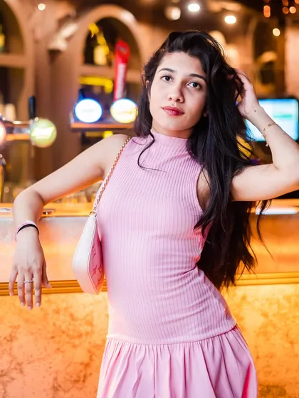 A guest in a pink dress, perfectly embracing the 'Tease Tuesday' theme.
