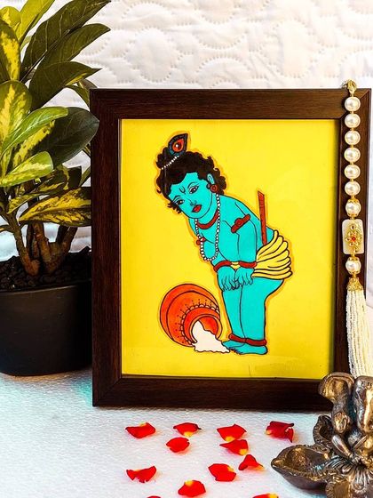 Here is Bala Krishna, the divine child, caught spilling a pot of buttermilk. This charming 9x10 inch framed painting is perfect for adding a touch of joy and innocence to your home.
