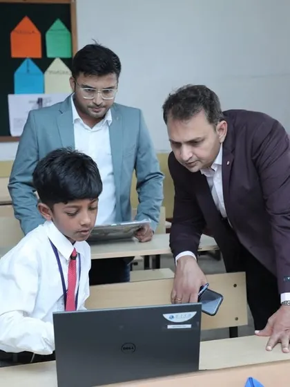 Our founder, Dhananjay Singh, leans in to get a closer look at a student's coding project during the RW2024 competition. We believe in nurturing talent through direct interaction and encouragement.