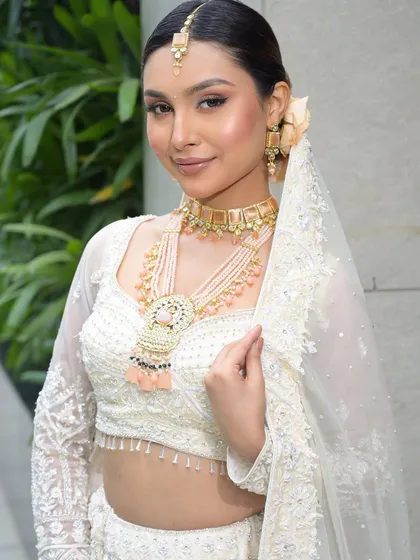 The bride with her veil, looking radiant and serene. The makeup is designed to look flawless from every angle and to photograph beautifully.