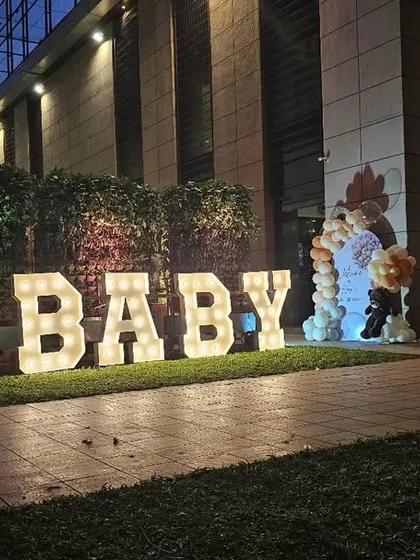 Make a big statement with large, illuminated "BABY" marquee letters for an outdoor or evening event. They create a fantastic photo opportunity and add a touch of glamour.