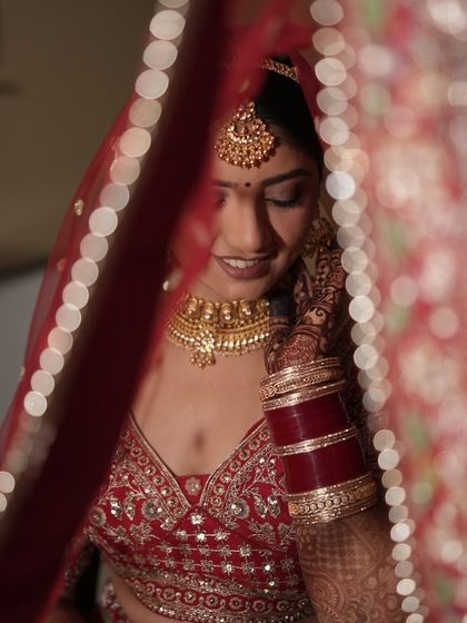 A classic bridal portrait of Bhawna. I love this shot through the dupatta, which highlights the soft smokey eye and the rich color of her lipstick.