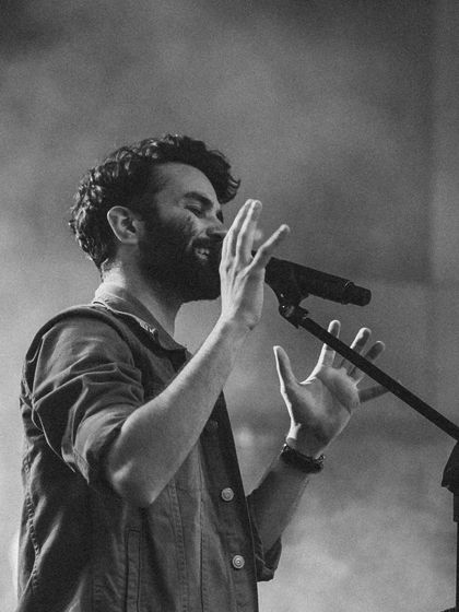 A monochrome shot capturing a quiet, emotional moment during a live performance. Whether it's a high-energy song or a soft ballad, I always sing from the heart.